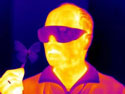 Infrared image of Radislav Potyrailo holding a butterfly