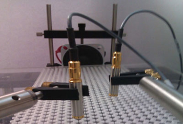 A photograph of the set-up used to confirm the presence of Dirac cones in sound waves on the surface of a Plexiglas sheet