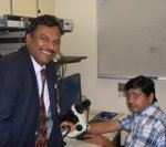 Vinayak Dravid (standing) and Gajendra Shekhawat near the instrument at Northwestern University where SNFUH was developed.