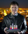 Above San Francisco Bay, Conrad Burke holding light-emitting solution processed silicon nanocrystals.