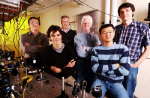 Georgia Tech researchers pose with equipment used to demonstrate entanglement of qubits.