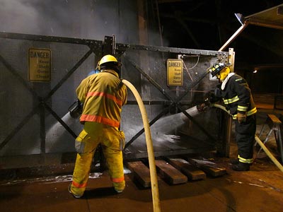 Photo of firefighters sending foam and water down the Soudan Mine access shaft