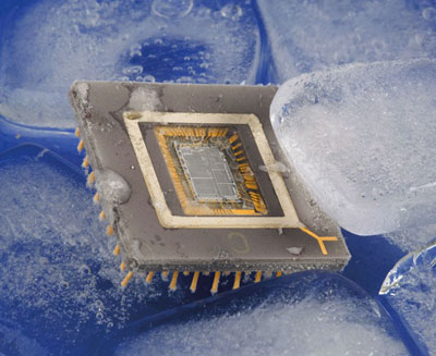 Photograph of a computer chip, floating in water, surrounded by ice cubes