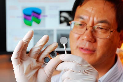 Photograph of Zhong Lin Wang holding the components of a new self-charging power cell