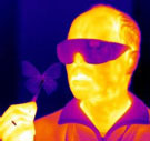 Infrared image of Radislav Potyrailo holding a butterfly