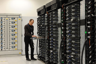 Researcher Peter Boyle with a supercomputer